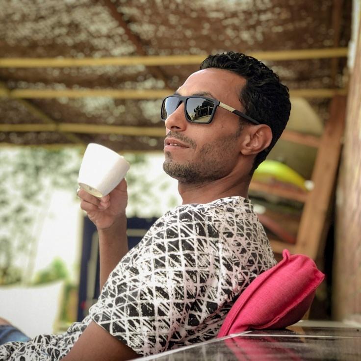 Avery Singh, Lead Design Curator at WellCrestQuiet, reviewing corporate floral arrangements